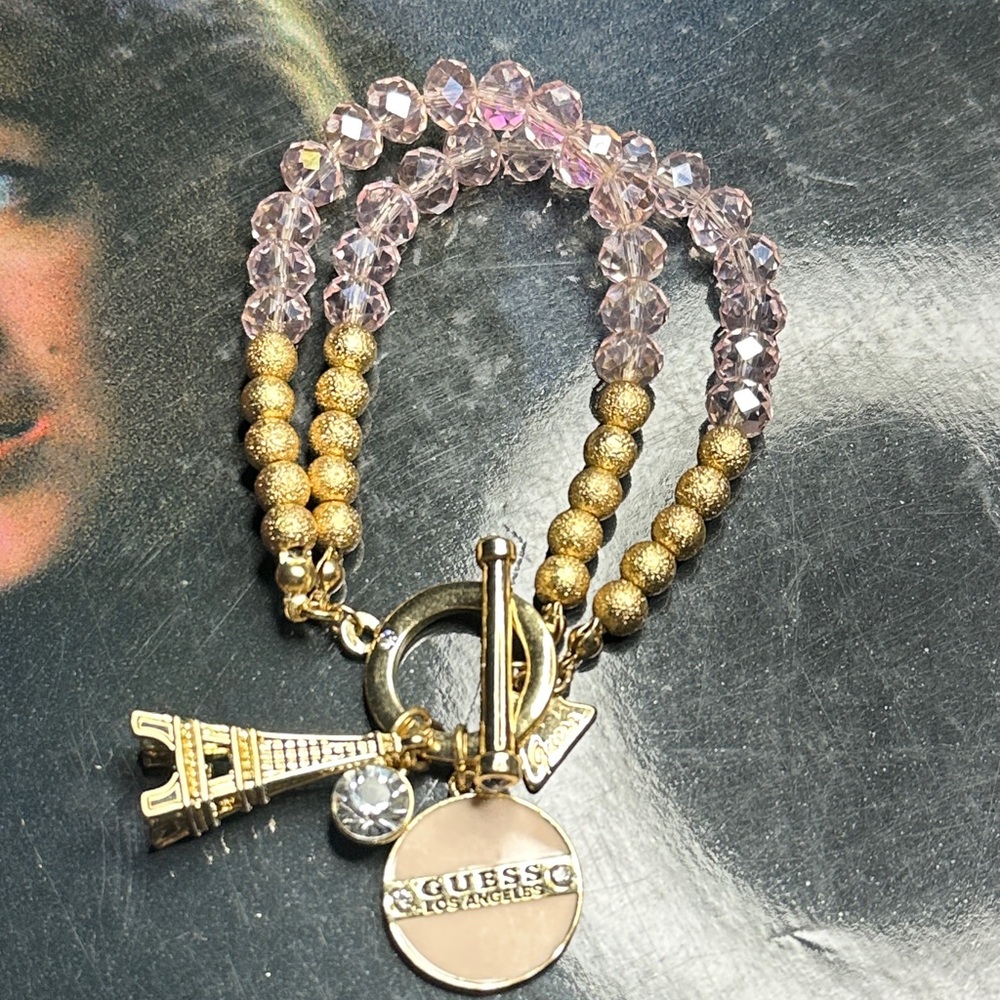Guess Gold and Pink Charm Bracelet With Eiffel Tower Bracelet